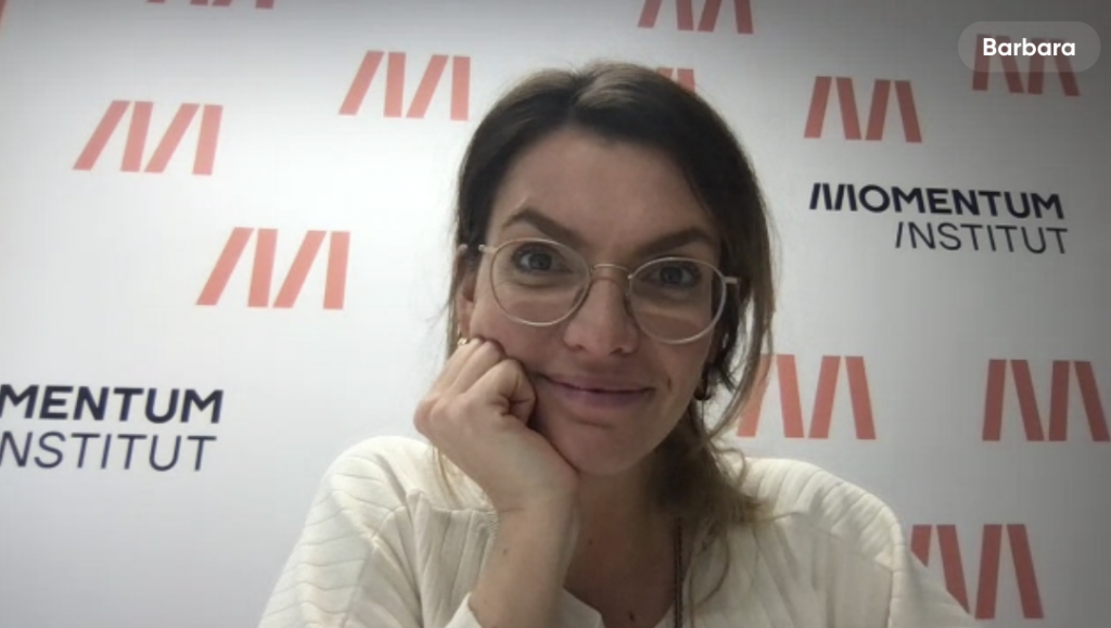 Barbara Blaha vor einem Banner des Momentum Institut